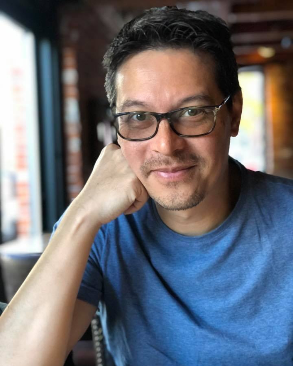 Mike Zimmermann headshot in a casual setting